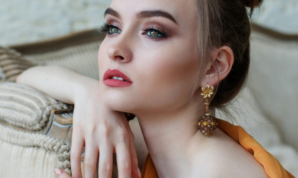 pexels-photo-458766-458766 Stunning close-up portrait of a woman with elegant makeup and jewelry, epitomizing modern fashion and beauty.